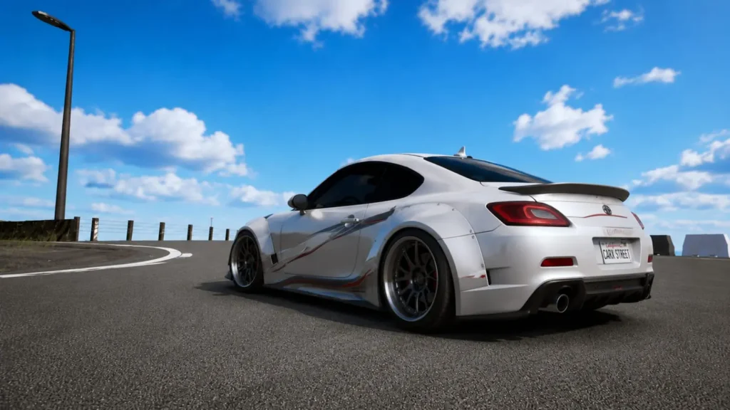 Home 2 Customized Toyota GR86 parked on a coastal road in CarX Street with a widebody kit and aftermarket wheels.